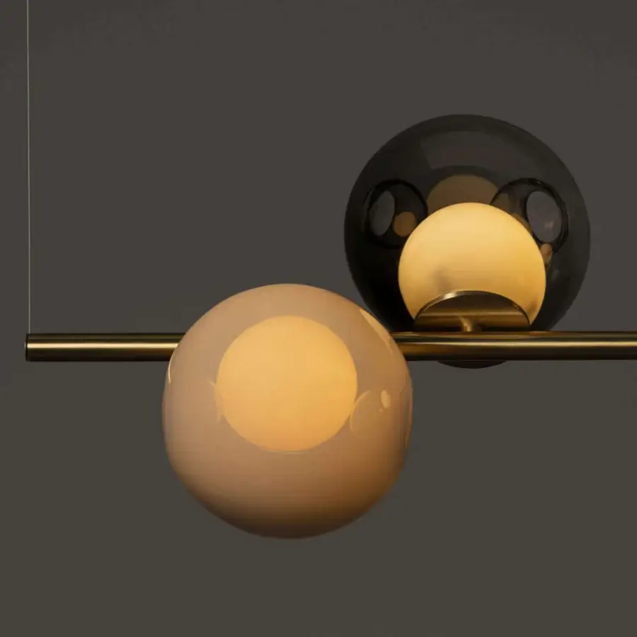 Elegant Bocci 28 Stem suspension lamp with clear glass exterior and milk white interior lamp holders in unlacquered brass