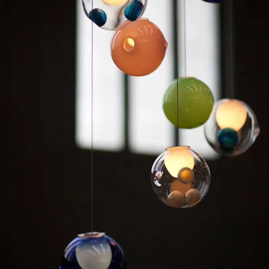 Distinguished Bocci 28 Random suspension lamp crafted with clear glass, milk white interior, and glossy finish showcasing floating blue and orange elements