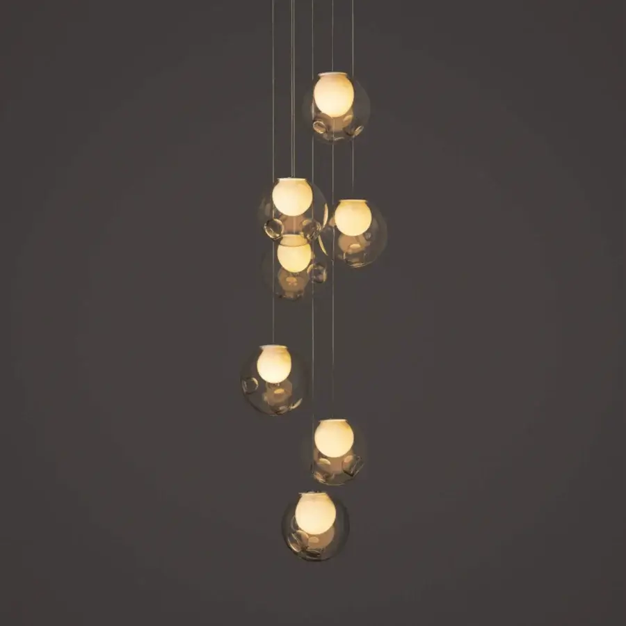 Distinguished Bocci 28 Random suspension lamp crafted with clear glass exterior and milk white interior lamp holder cavities exhibiting a cascading arrangement