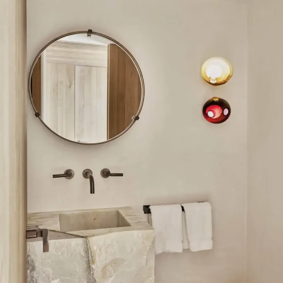 Elegant Bocci 28s lamp crafted with clear glass exterior and milk white interior, showcasing a gradient red to orange shade in a dark matte frame