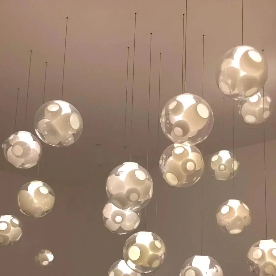 Captivating Bocci 38V Single Suspension Lamp lighting fixture crafted in clear glass with milk white interior cavities