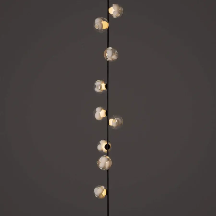 Elegant Bocci 38V Stem ceiling lamp with a slender black metal stem and clear glass shades containing milk white interiors