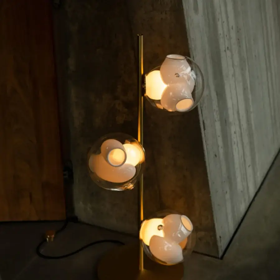 Elegant Bocci 38V Stem floor lamp with brass and clear glass crafted with a milk white interior and polished finish