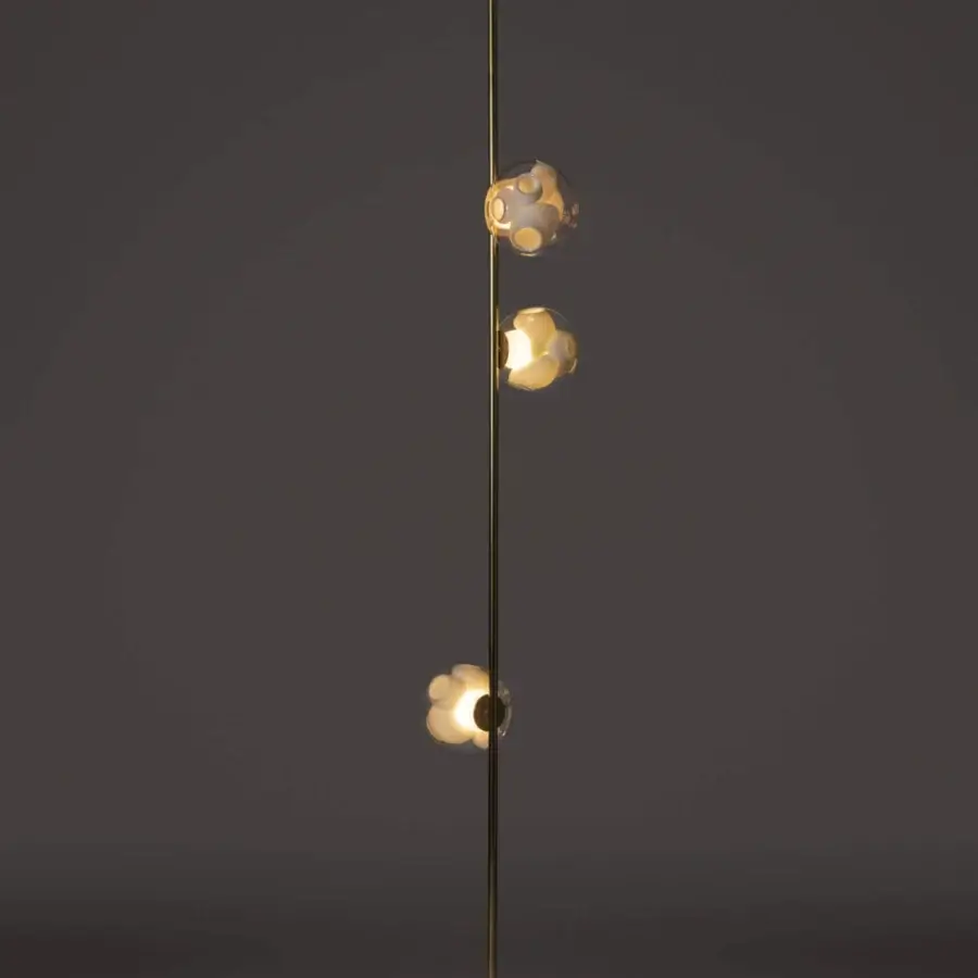 Captivating Bocci 38V Stem floor lamp with brass finish and clear glass shades casting a warm glow