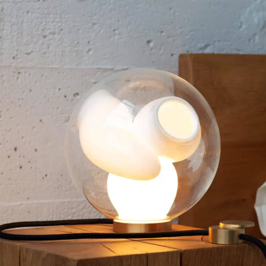 Captivating Bocci 38V Table Lamp with a clear glass exterior and milk white lamp holder cavities crafted in brass
