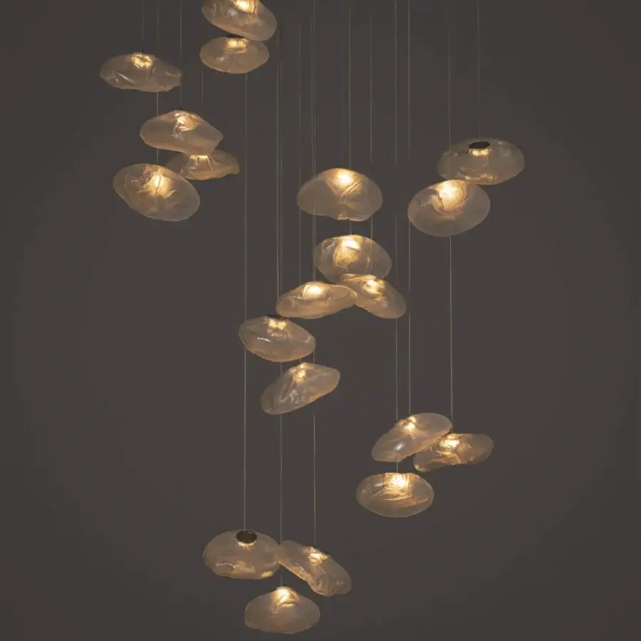 Distinguished Bocci 73 suspension lamp with hand-blown glass pendants nestled within folded ceramic fabric vessels in a warm beige hue