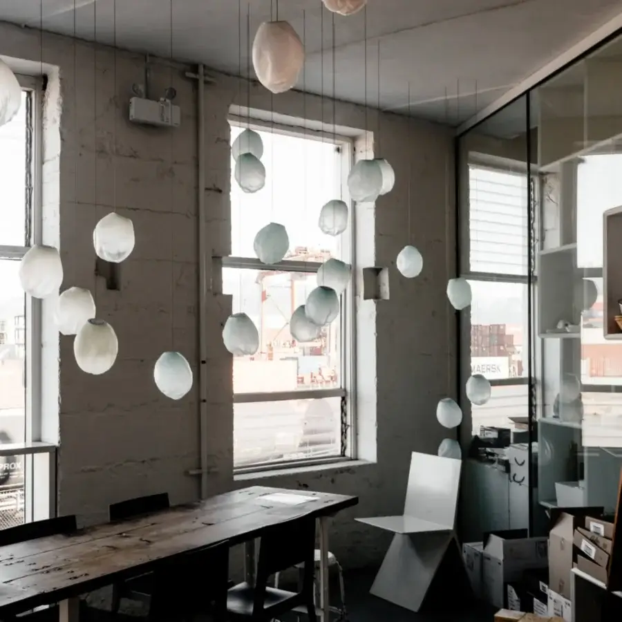 Exclusive Bocci 73V single suspension lamp crafted in off-white glass with a matte finish and braided metal coaxial cable