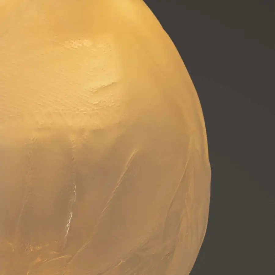Exceptional Bocci 73V single suspension lamp in warm yellow glass with a heavily textured matte finish and braided metal coaxial cable