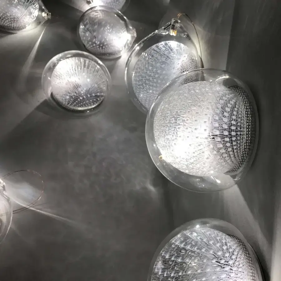 Elegant Bocci 76 Surface Light fixture crafted in hot white and clear glass with delicate copper mesh detailing