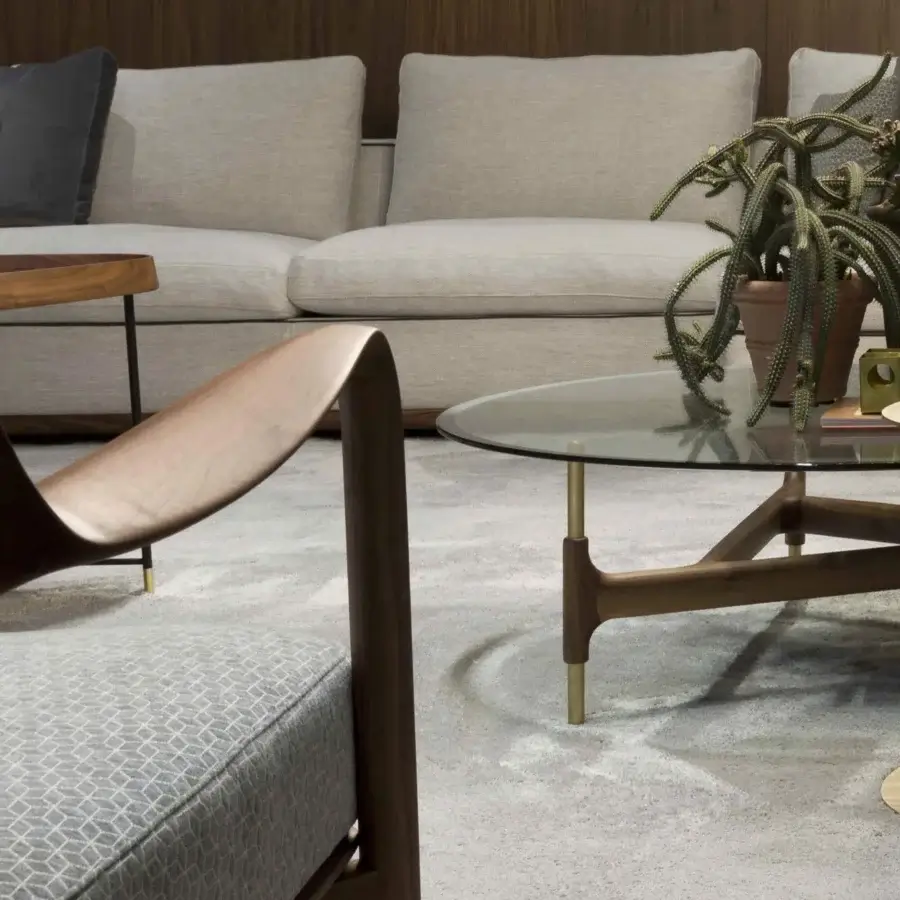 Distinguished Porada Louis lounge chair with solid Canaletto walnut frame and light gray patterned textile upholstery