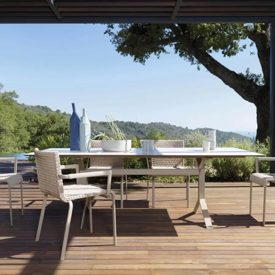 Sophisticated Roberti Rattan Key West table with powder coated aluminum structure and white HPL top