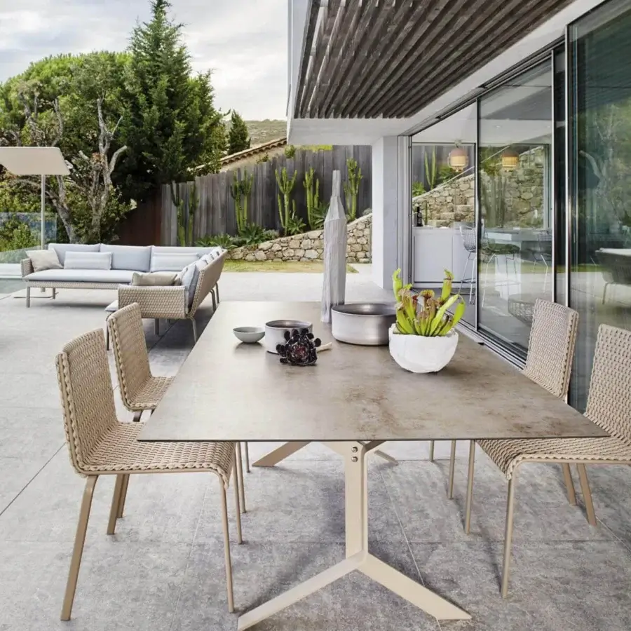 Exclusive Roberti Rattan Key West table with speckled matte HPL top and beige powder-coated aluminum pedestal base