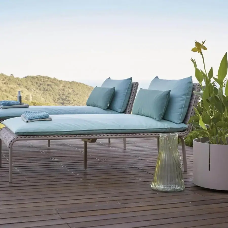 Superior Roberti Rattan Key West lounger in light brown with powder-coated aluminum and Sunrope weaving, complemented by pale blue cushions