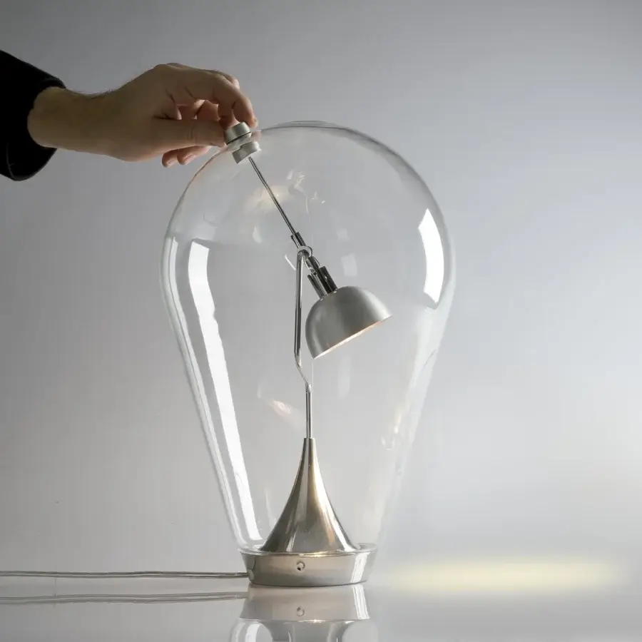 Elegant Lodes Blow table lamp with transparent blown glass shade and adjustable brushed silver metal interior