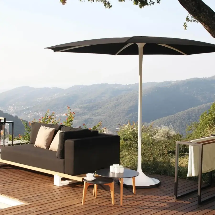 Innovative Royal Botania Palma umbrella, a strutless shading solution with dark woven acrylic fiber and white powder-coated aluminum pole