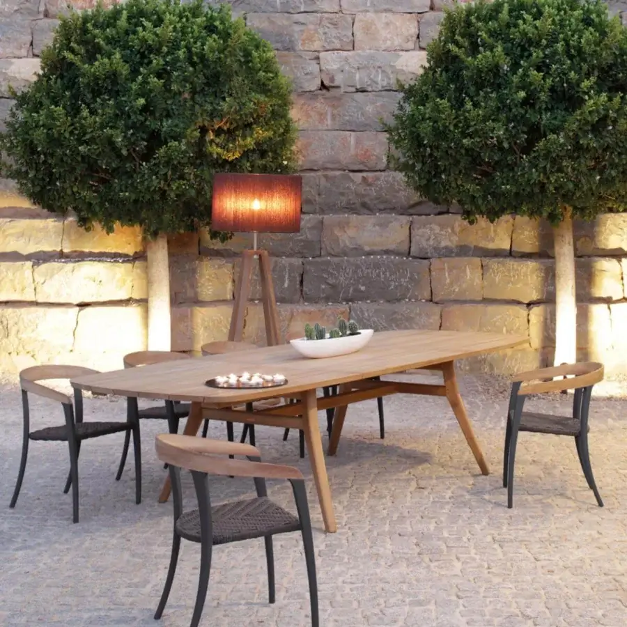 Harmonious Royal Botania Jive armchair with dark aluminum structure, teak backrest and woven olefin seat