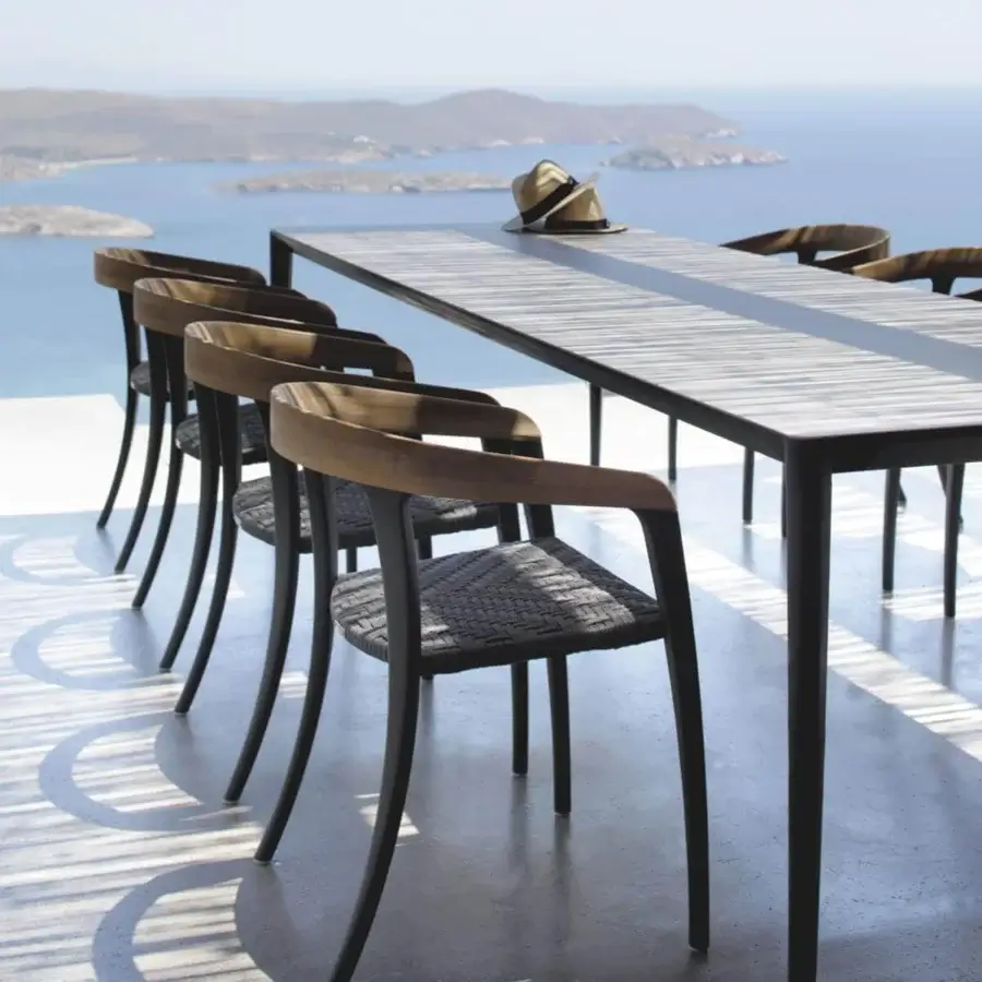 Harmonious Royal Botania Jive armchair built with tapered aluminum, teak, and a woven olefin seat offering a balanced aesthetic