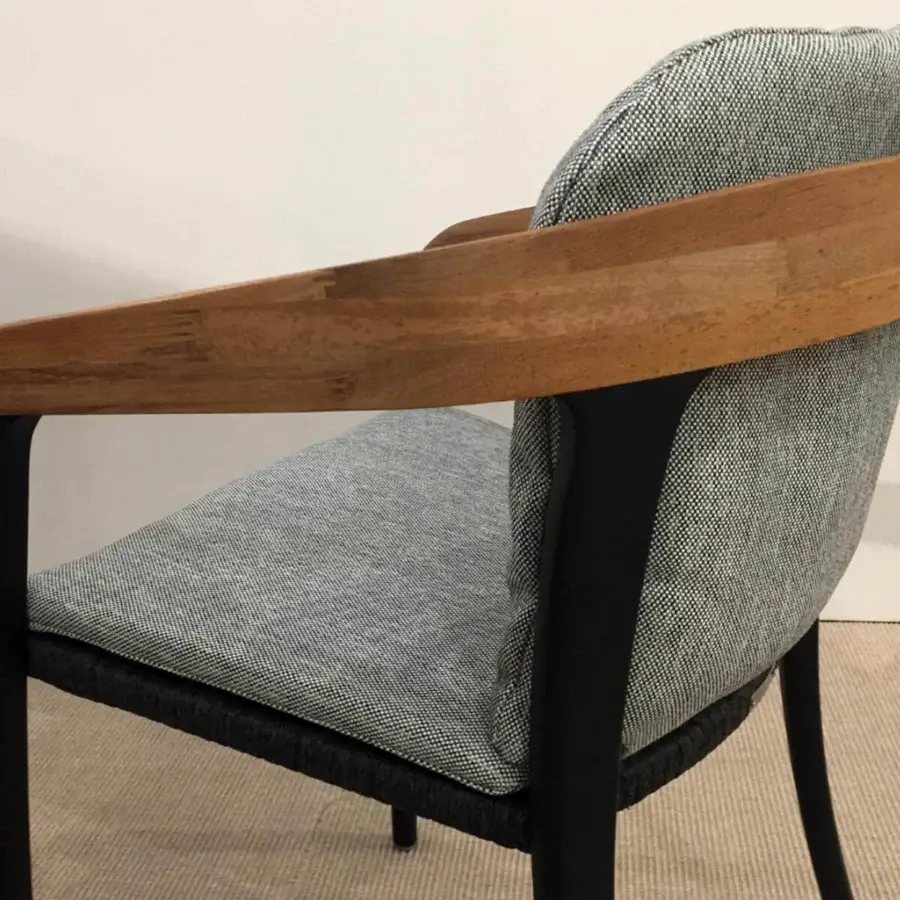 Sophisticated Royal Botania Jive armchair built with tapered aluminum, woven olefin, and light brown teak accents with a matte finish