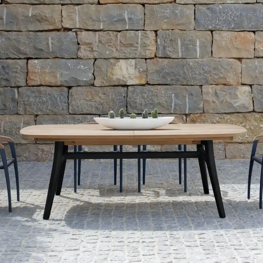 Refined Royal Botania Zidiz table crafted from teak wood with a light natural finish and dark angled legs