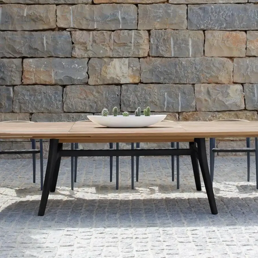 Superior Royal Botania Zidiz table built with teak wood and a dark metal frame in a contemporary smooth finish