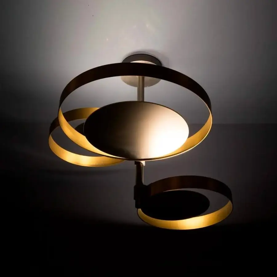 Elegant VENICEM Circle ceiling lamp with intersecting bands crafted in burnished natural brass and matt black nickel