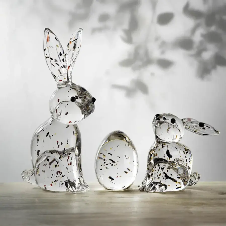 Glass rabbit sculptures by Duccio Di Segna on wood, speckled clear glass, upright and seated poses with an egg shape.