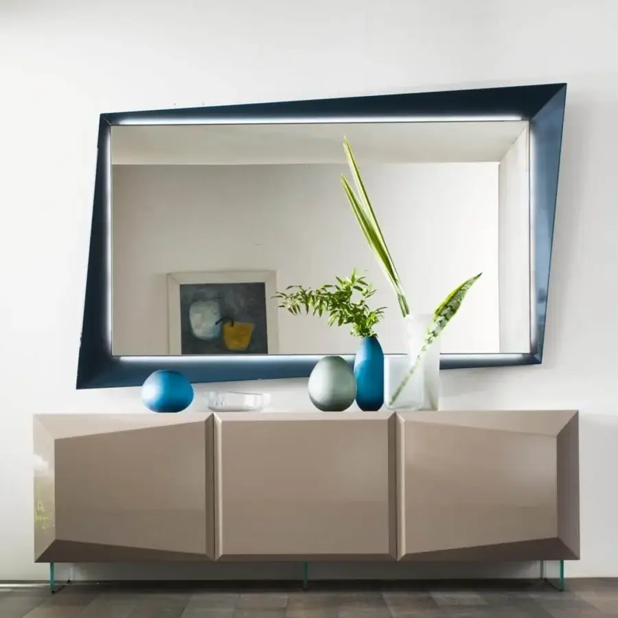 Sophisticated Reflex Quartz mirror with asymmetric silhouette and dark glossy metal framing, illuminated with integrated lighting and extra clear glass
