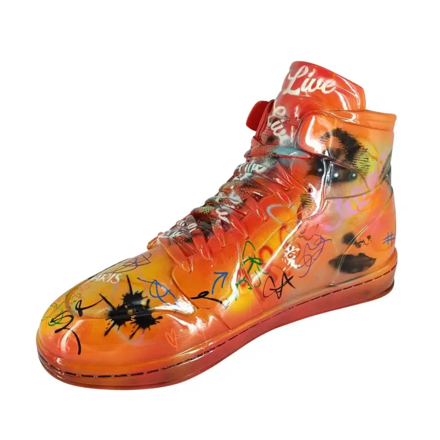 Exclusive Juliarte Sneaker sculpture hand-painted with vibrant orange gradients and graffiti markings in stone powder and fiberglass with a glossy finish