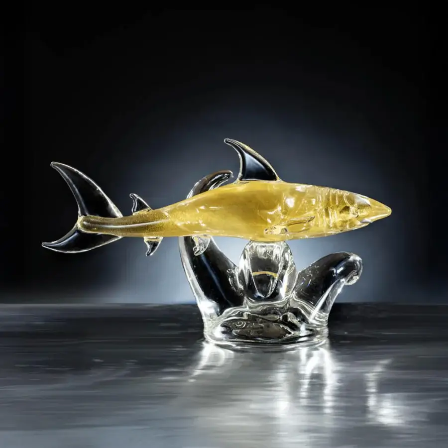 Glass shark tiger sculpture, amber and clear, with swirling clear glass base resembling ocean waves and a whale form.
