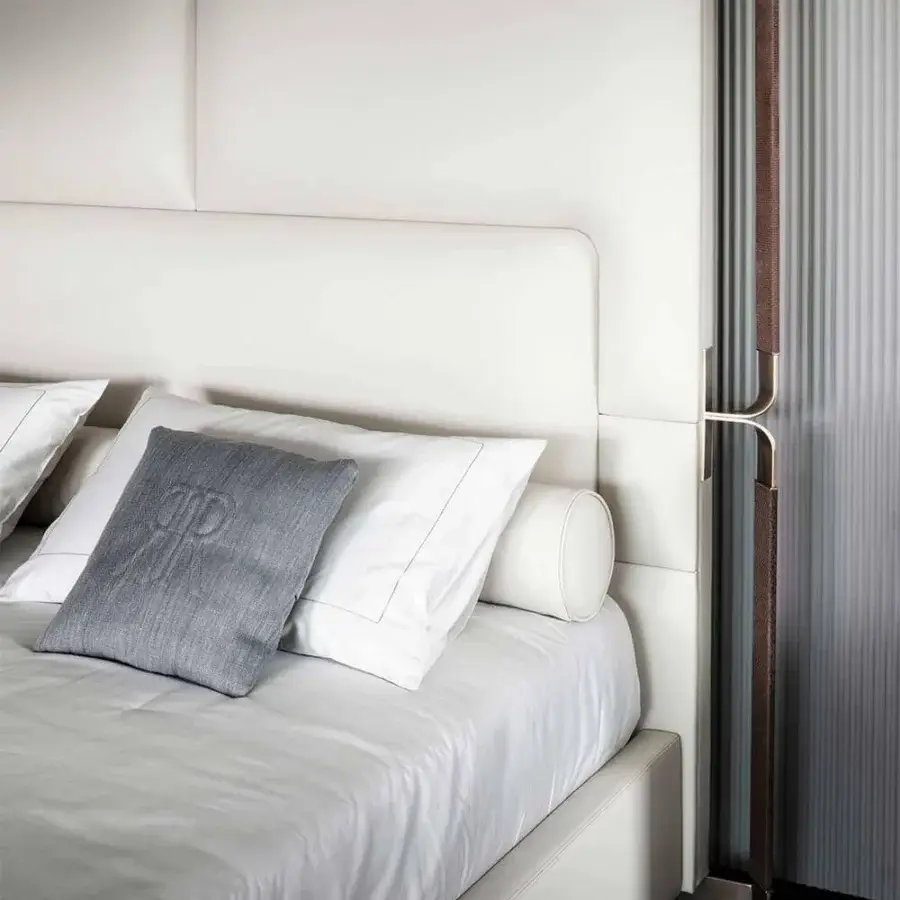 Superior Rugiano Grace bed with a tall upholstered headboard and refined bronze detailing in light cream fabric