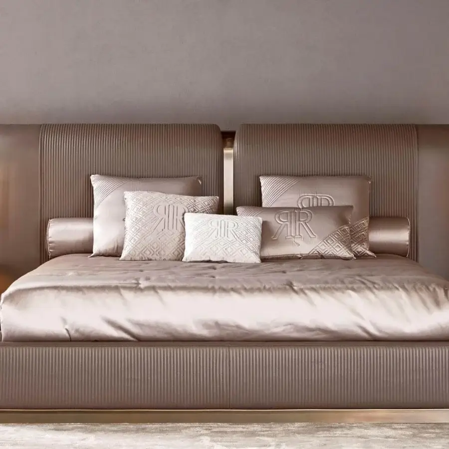 Exceptional Rugiano Vogue bed with champagne textile upholstery, vertical channel detailing and bronze metal accents