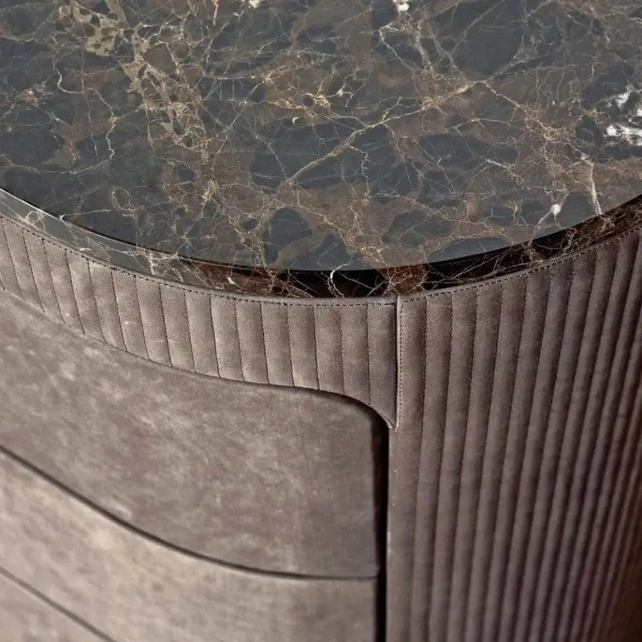 Elegant Rugiano Vogue dresser with brown textile and dark marble top exhibiting a curved silhouette