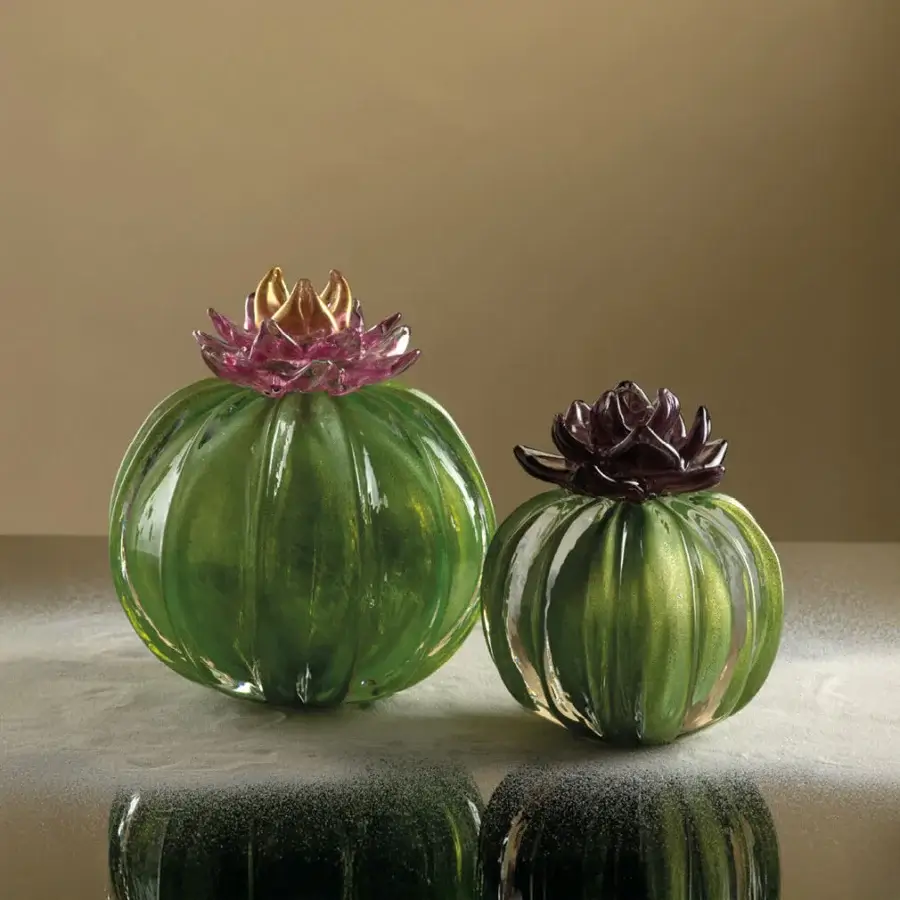 Glass cactus sculptures by Duccio Di Segna, green and magenta petals, silver reflective surface, neutral beige background.