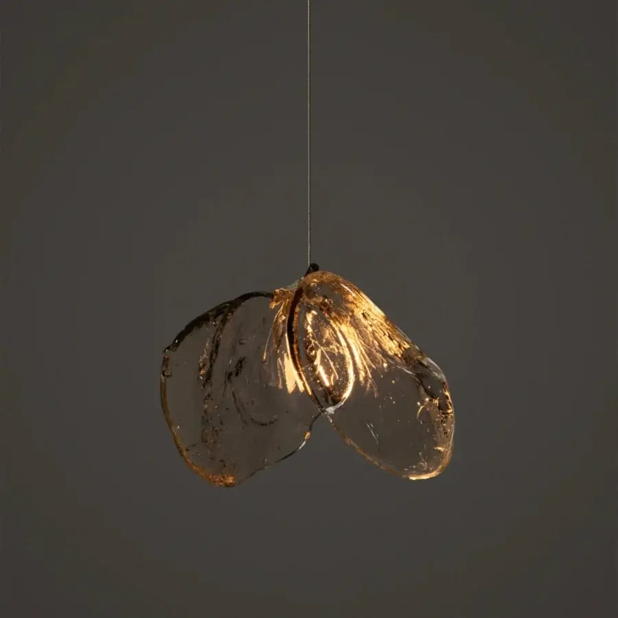 Captivating Bocci 141 single suspension lamp crafted in clear glass with warm amber and golden hues when illuminated by coaxial cable