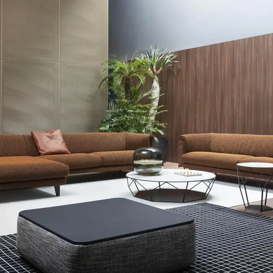 Elegant Bonaldo Saddle sectional with textured brown textile upholstery and a leather insert in the armrest with short metal feet