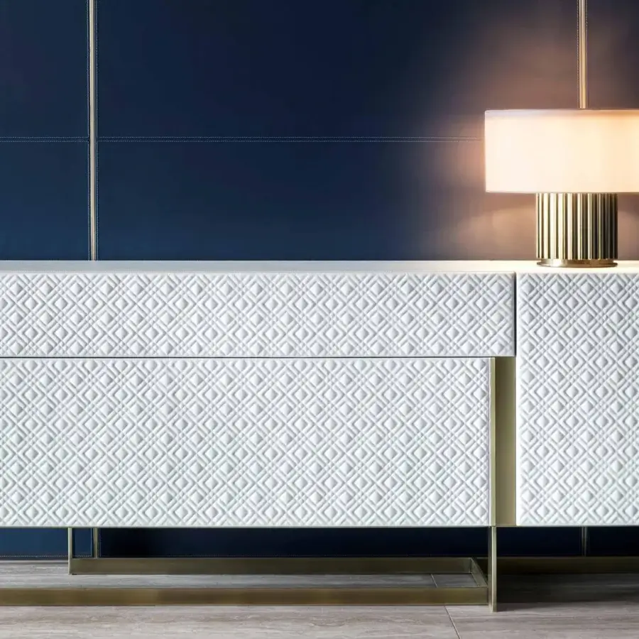 Distinguished Rugiano Blade sideboard with white textured finish, leather doors and refined matelassé embroidery in a steel base
