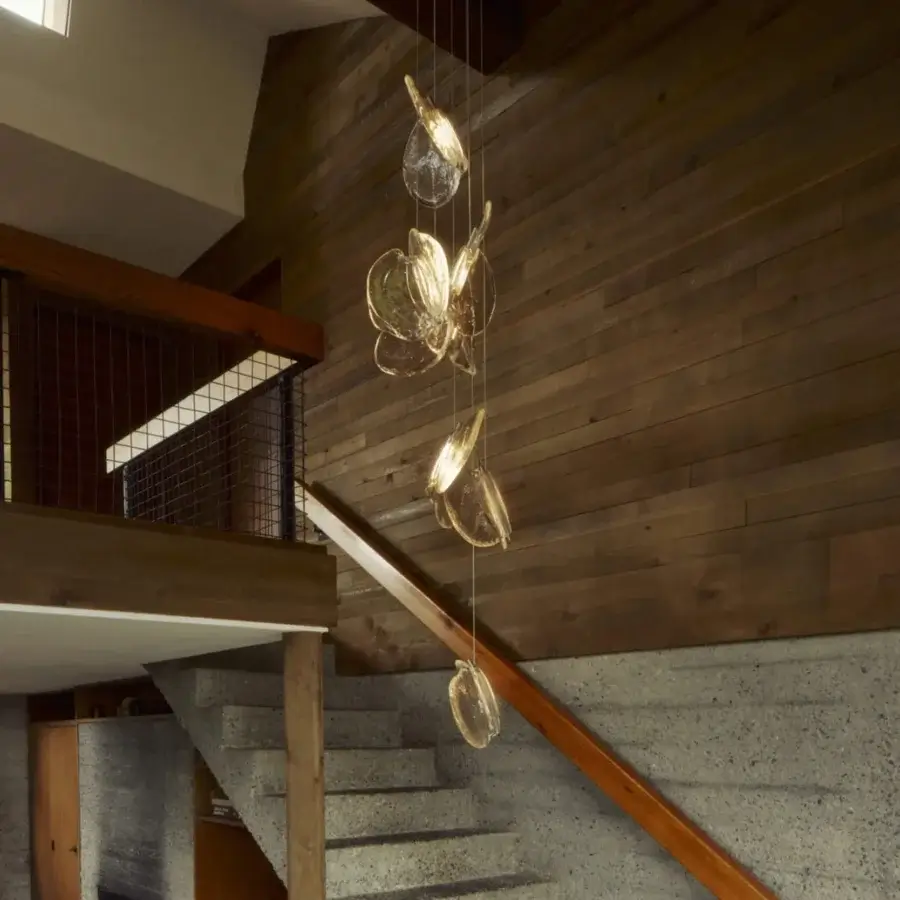 Captivating Bocci 141 Random suspension lamp with warm amber glass pendants and dark-toned metal canopy crafted in textured glass