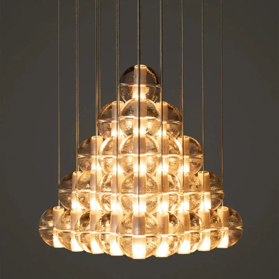 Exclusive Bocci 14 Geometric suspension lamp with numerous transparent glass elements and light-colored metal wires exhibiting a warm glow