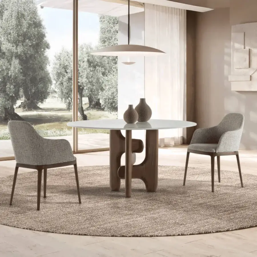 Harmonious Pacini & Cappellini Clifford table with polished natural marble tabletop and solid Canaletto walnut base showcasing textured grain