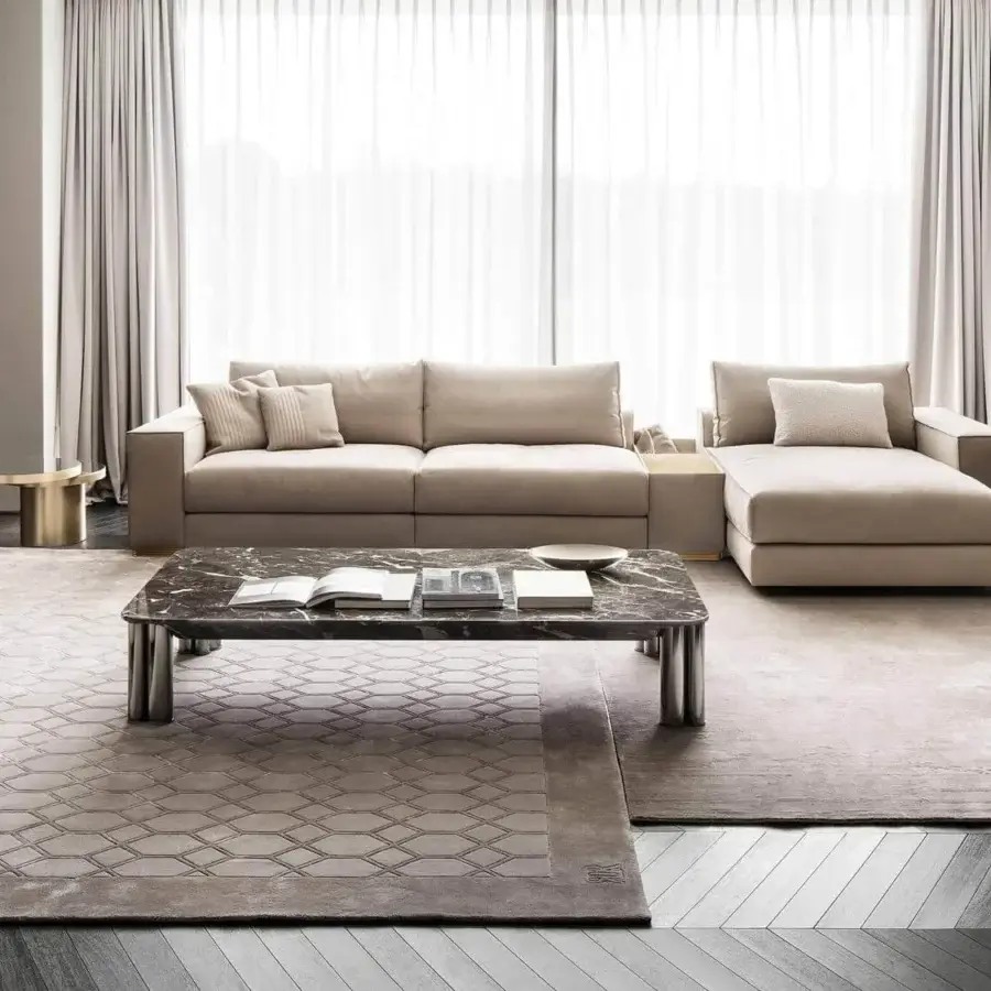 Elegant Rugiano Paris lounge chair with textured light beige textile upholstery and dark-toned twisted metal structure