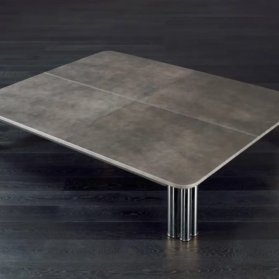 Superior Rugiano Forest coffee table with a gray textured leather top and skillfully welded polished brass with black chrome legs