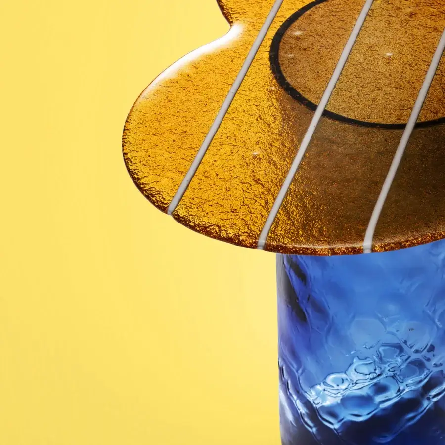 Captivating Miniforms Striche side table with amber and deep blue molten glass exhibiting glossy sculptural lines