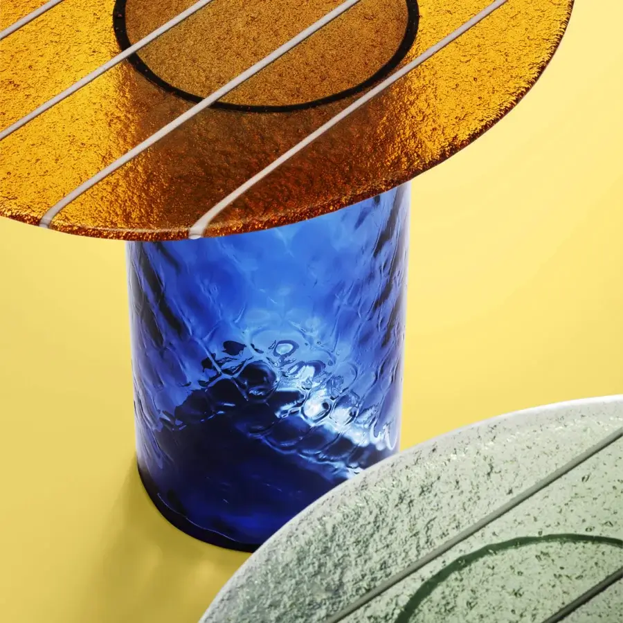 Distinguished Miniforms Striche side table with cobalt blue textured glass column and golden-brown, grayish-green discs exhibiting linear grooves
