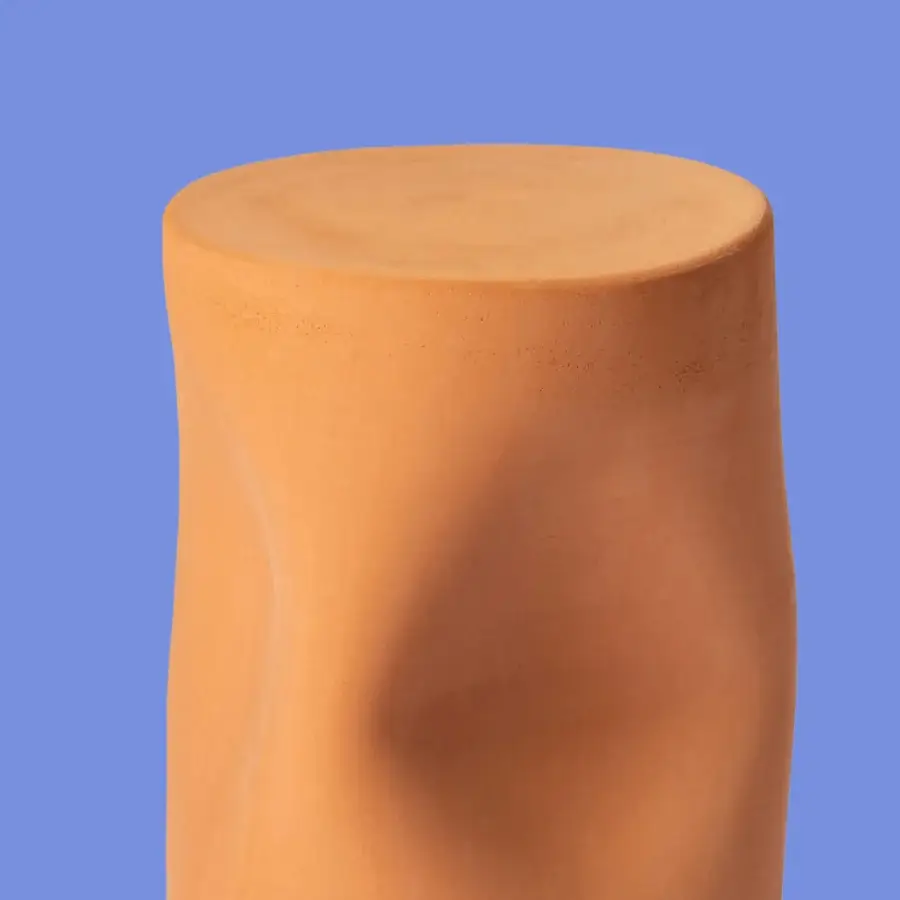 Distinguished Miniforms Toblo side table with uniquely sculpted terracotta form and warm muted orange finish