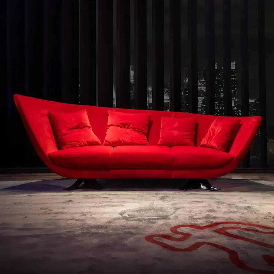 Captivating Joker Home Collection sofa with curved form, vibrant red velvet upholstery and a matte finish