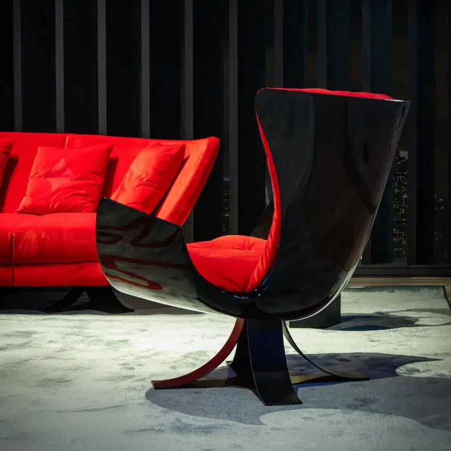 Lavish Joker Home Collection sofa with daring curved forms upholstered in deep red velvet and glossy finish