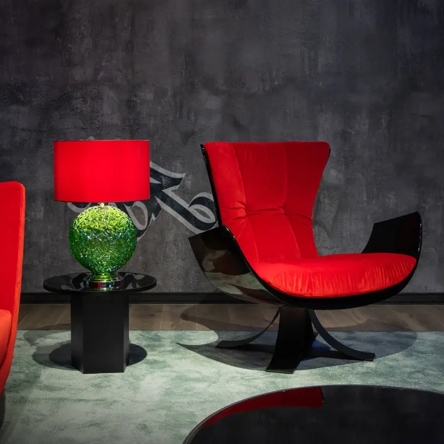 Lavish Joker Home Throne lounge chair sculpted from hand-finished fiberglass enveloped in rich red velvet with a dark glossy wood-like frame