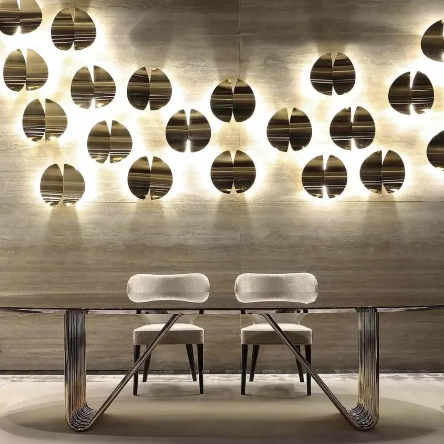 Lavish Rugiano Duo wall lamp crafted in golden brass metal with a glossy sheen and bisected circular arrangement