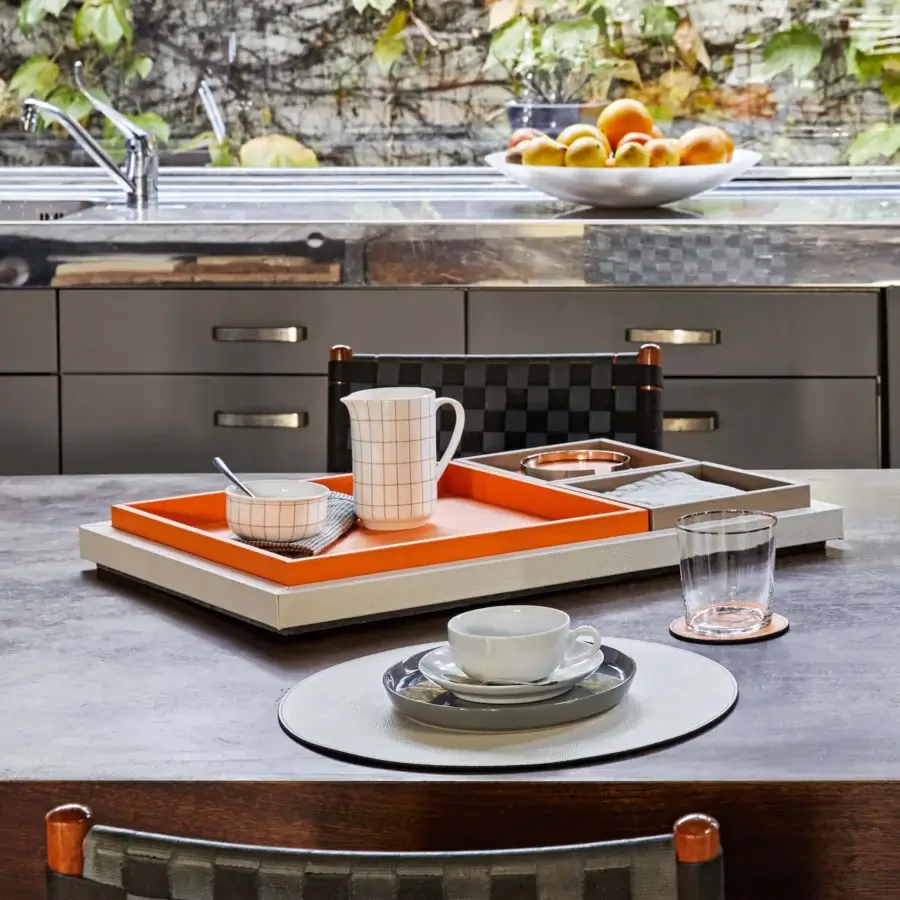 Superior Pinetti Samurai trays in vibrant orange calfskin leather with a color-blocked gray perimeter and skilled hand-stitched construction
