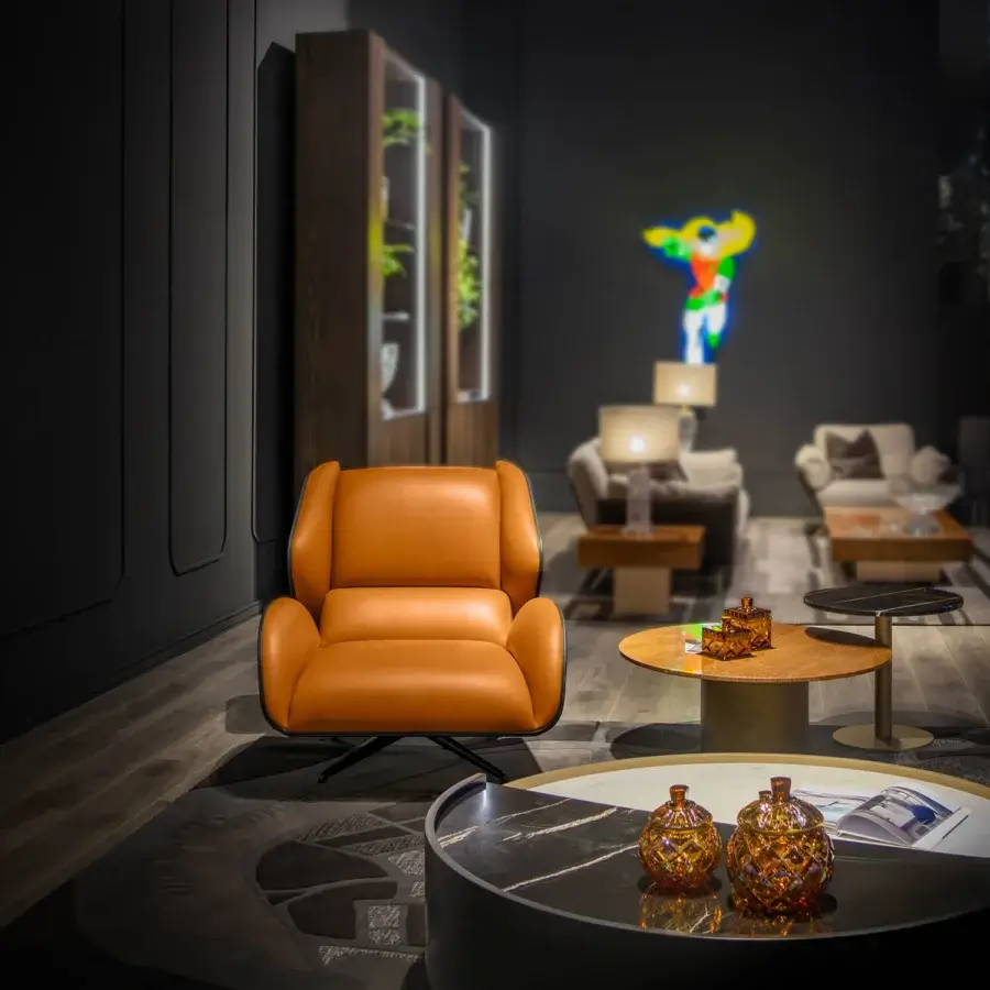 Distinguished WAYNE Enterprises WE-015 lounge chair with warm orange-brown leather upholstery and sleek metal base, crafted in Italy with a satin finish